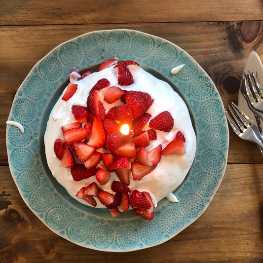 First Birthday Cake covered in fresh strawberries to celebrate a milestone for baby and parents