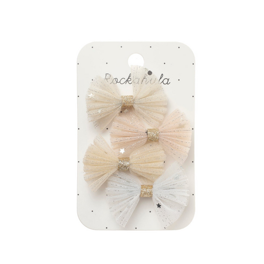 A set of four tulle hair bows in soft cream, beige, and white, each with a glittery gold band, attached to a white display card with the brand name 'Rocknrola'.